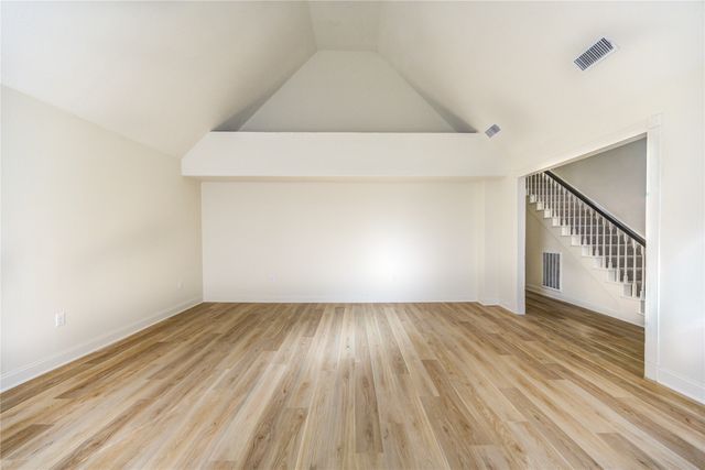 a view of an empty room and wooden floor