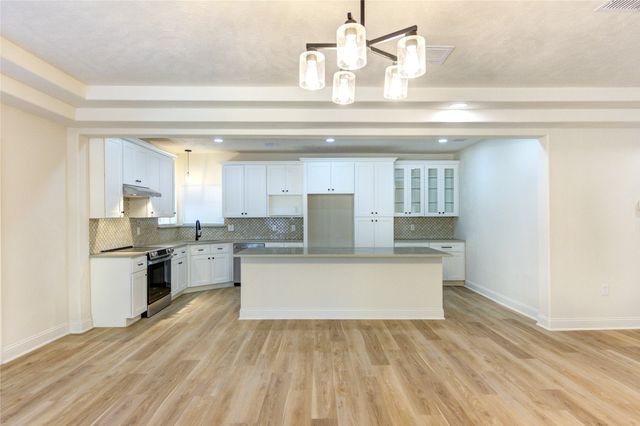 a view of kitchen with sink microwave and stove
