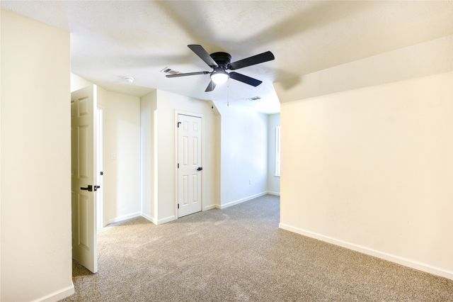a view of a hallway with a ceiling fan