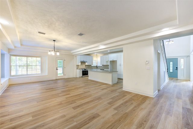 a view of a kitchen with wooden floor and a kitchen