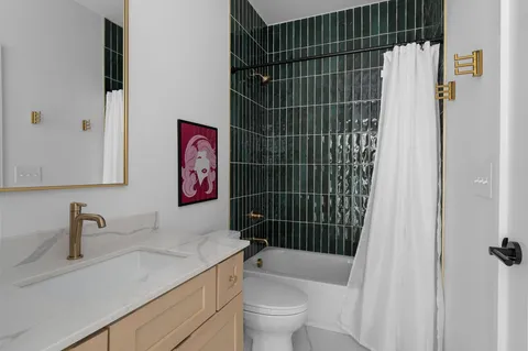 a bathroom with a sink toilet and shower