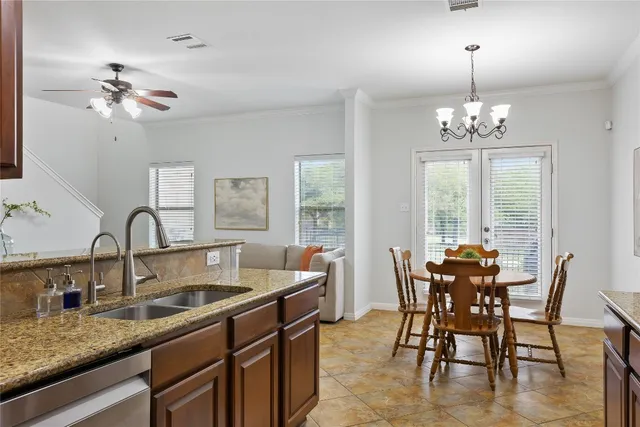 a dining room with furniture a chandelier and window