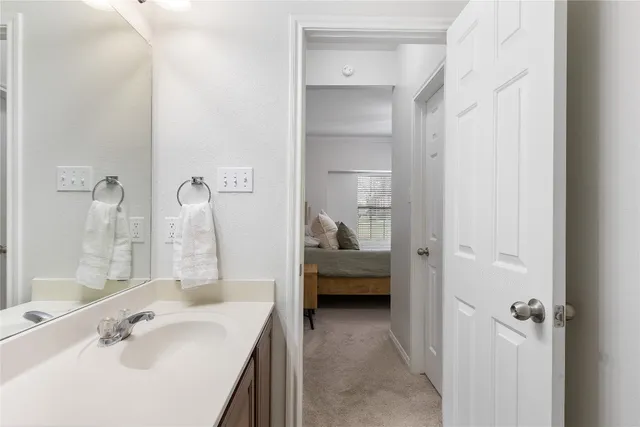 a en suite bathroom with a sink and a mirror