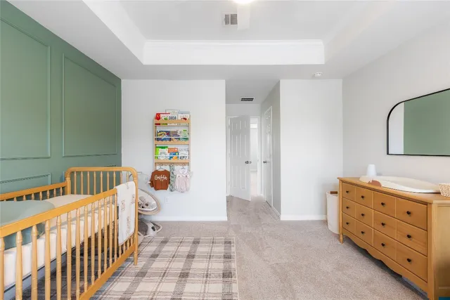a bedroom with furniture a baby crib and a window