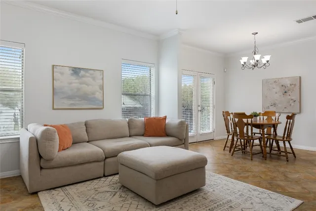 a living room with furniture wooden floor and a chandelier