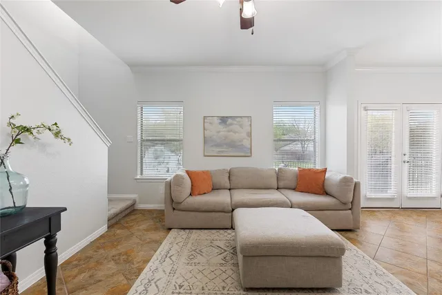 a living room with furniture and windows