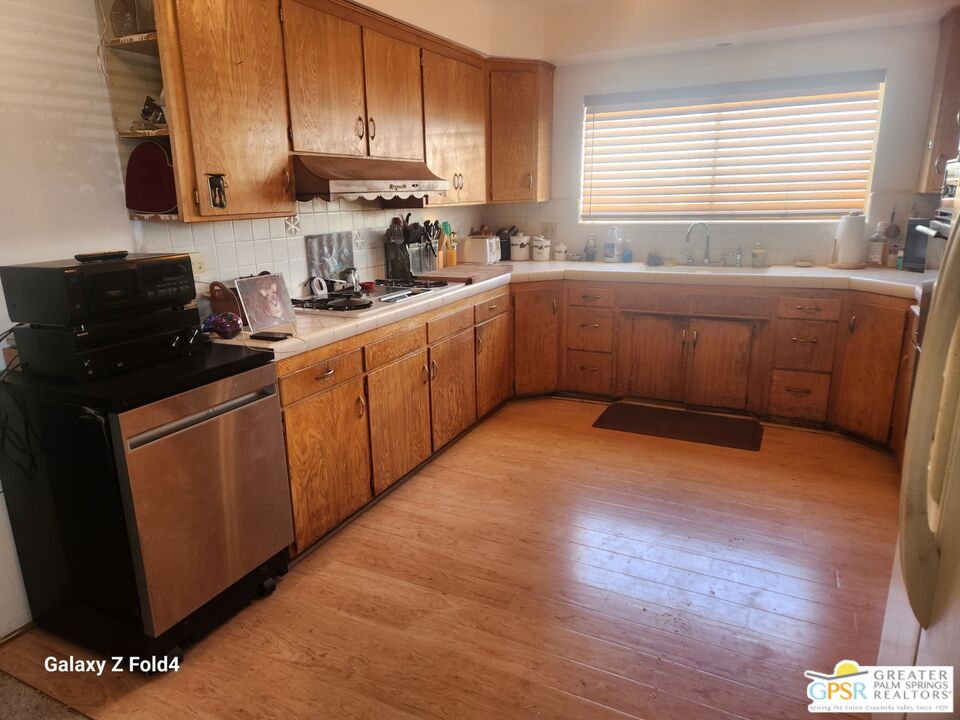 1385 Palm Avenue Beaumont, CA 92223 - Photo 4 of 13 a kitchen with stainless steel appliances granite countertop a sink a stove counter space and cabinets