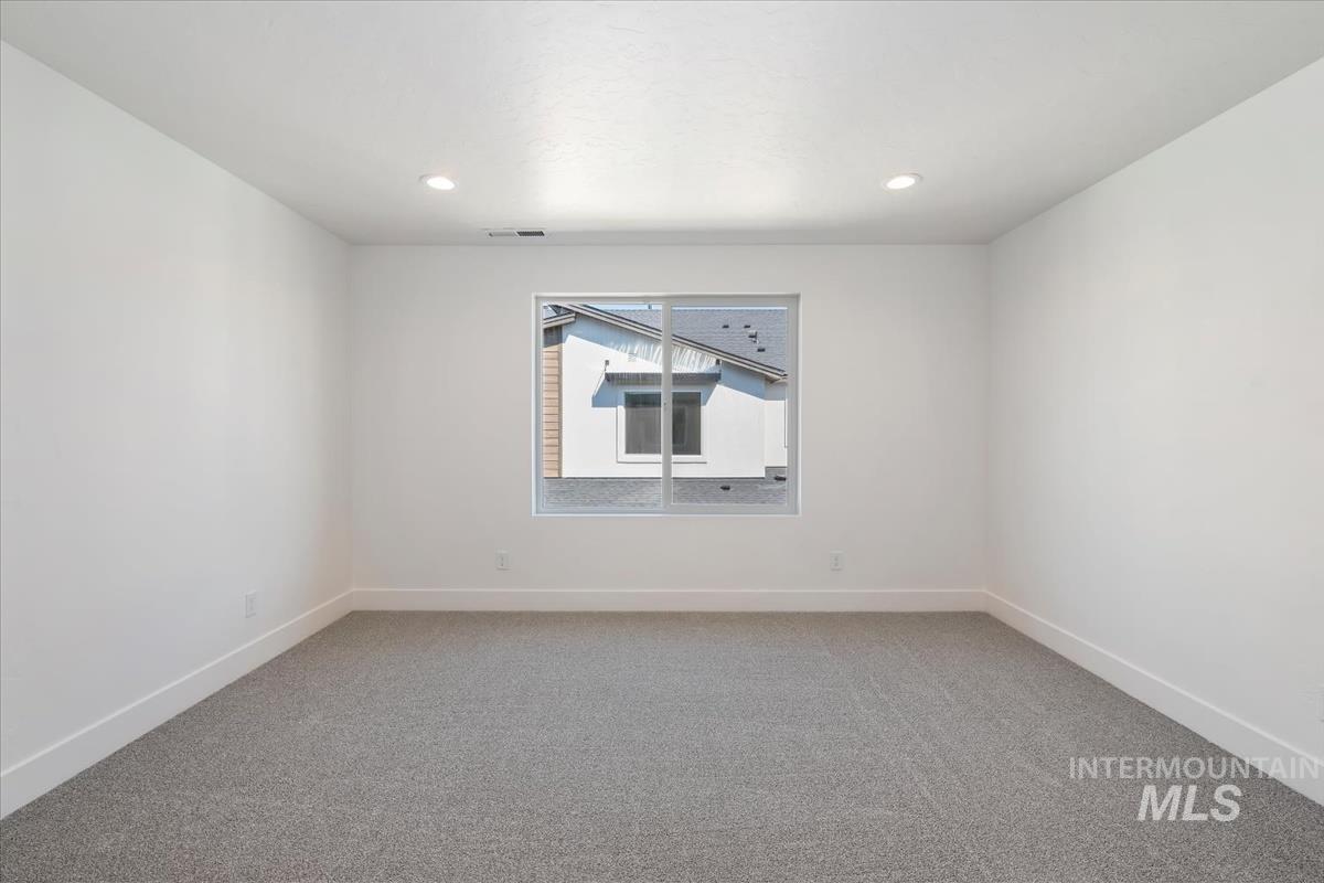 768 South Calhoun Lane Star, ID 83669 - Photo 21 of 36 Recessed lighting illuminates this room featuring light grey carpeting, white walls, and white baseboards