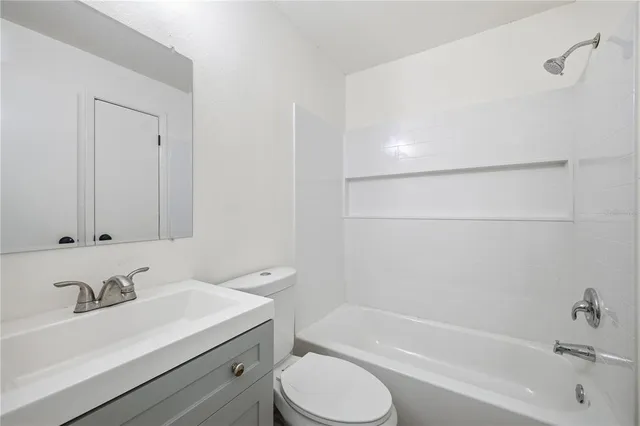 a bathroom with a sink toilet and tub