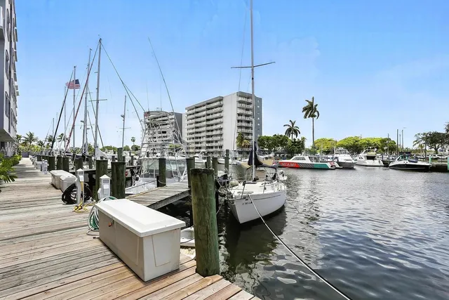 a view of a lake with boats and trees in the background