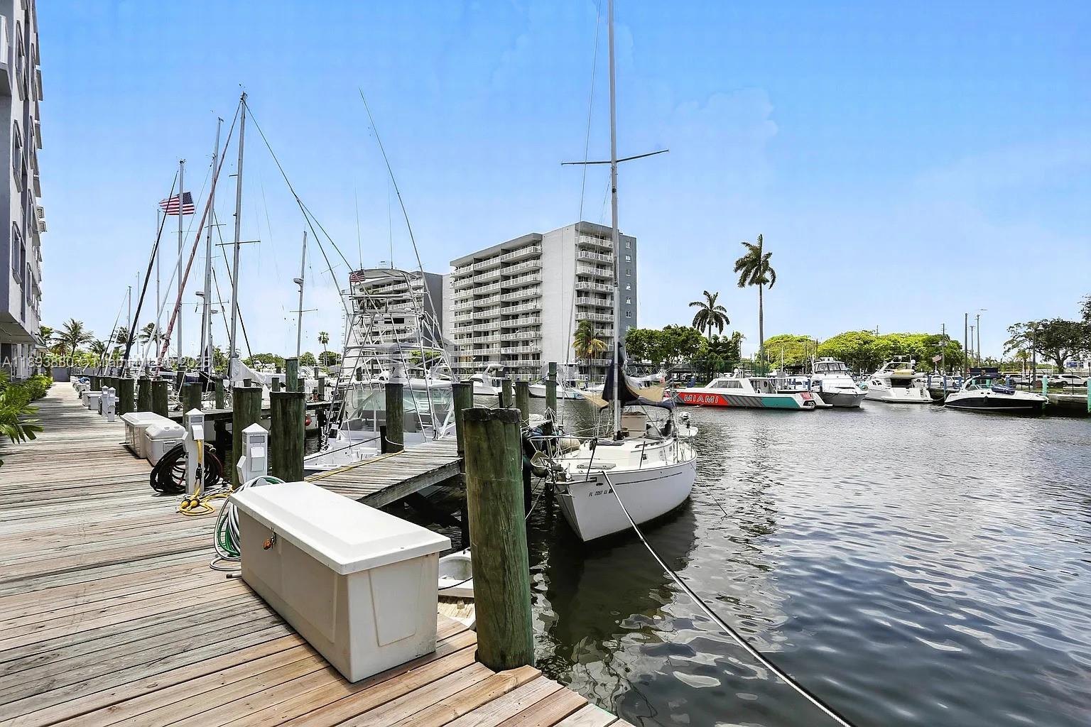 2415 Northwest 16th St Road, Unit 2031 Miami, FL 33125 - Photo 3 of 7 a view of a lake with boats and trees in the background