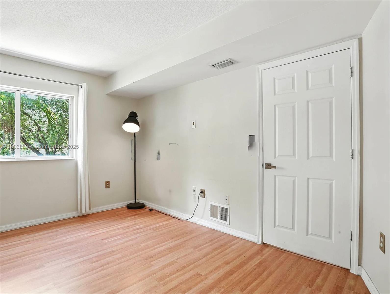2415 Northwest 16th St Road, Unit 2031 Miami, FL 33125 - Photo 6 of 7 a view of empty room with wooden floor