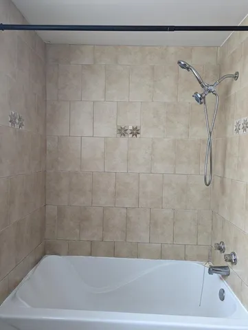 a bathroom with a shower and a sink