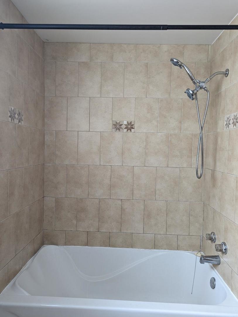 6134 West 79th Street, Unit 1 Burbank, IL 60459 - Photo 18 of 19 a bathroom with a shower and a sink