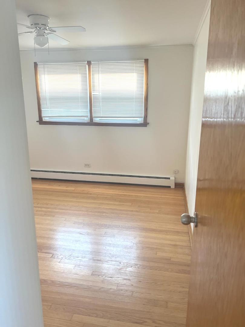 6134 West 79th Street, Unit 1 Burbank, IL 60459 - Photo 10 of 19 a view of a room with wooden floor and window