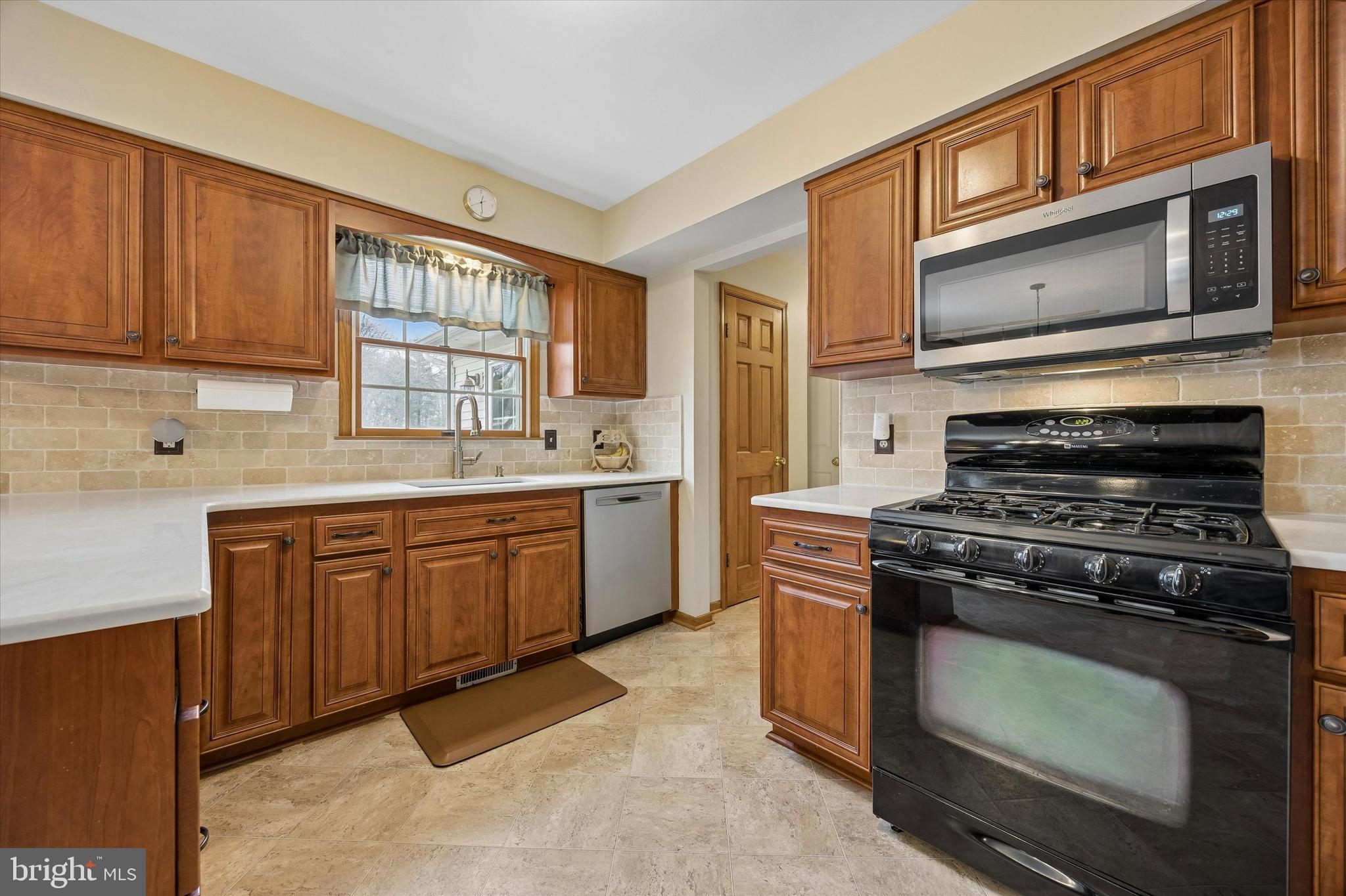 3 Valli Court Hamilton, NJ 08690 - Photo 16 of 48 a kitchen with stainless steel appliances a stove sink microwave and cabinets