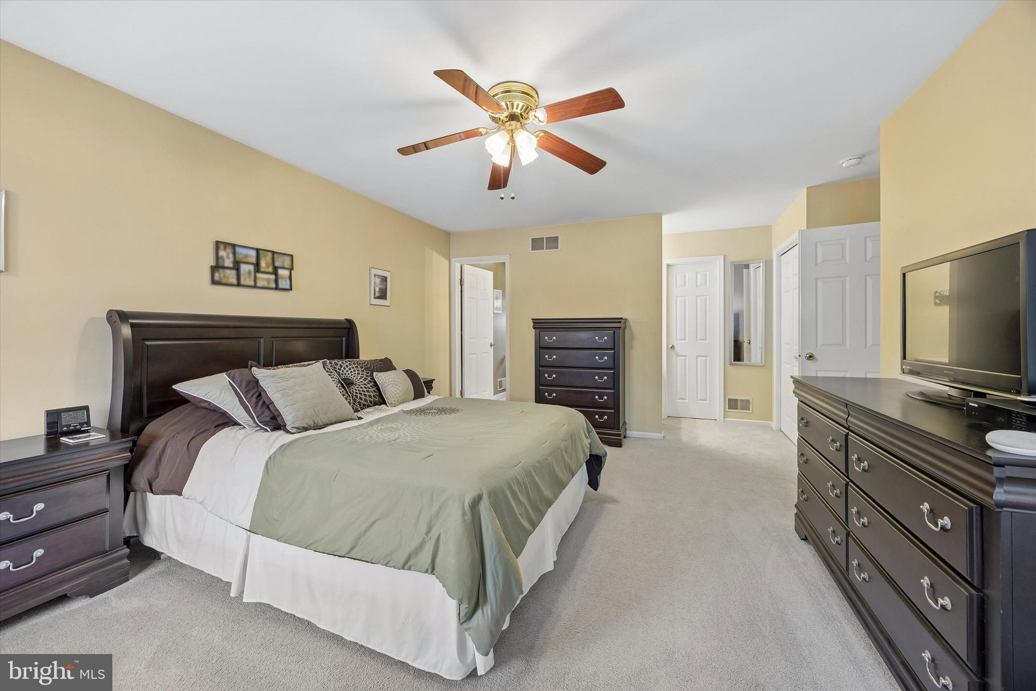3 Valli Court Hamilton, NJ 08690 - Photo 32 of 48 a spacious bedroom with a bed and a flat screen tv