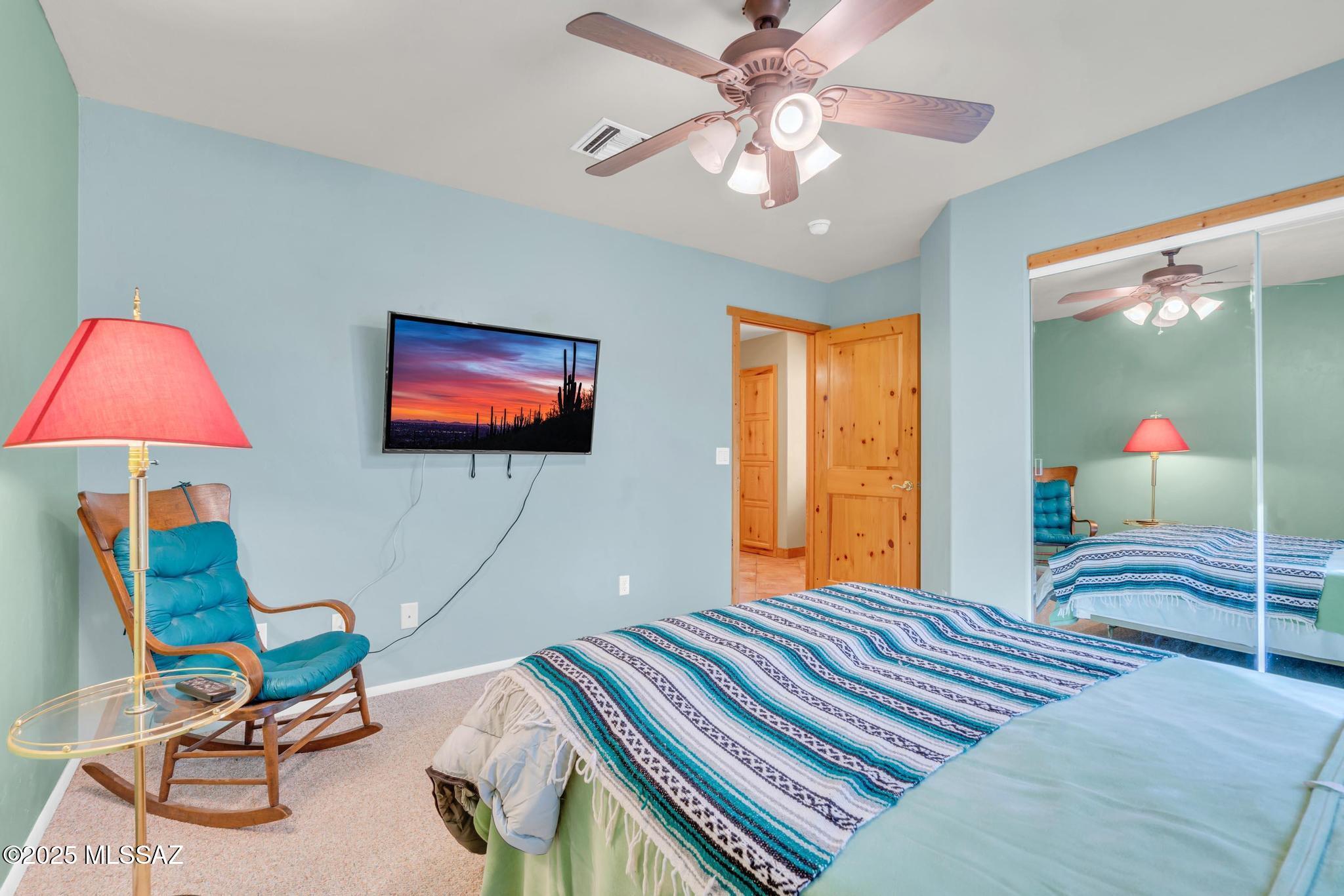 1794 Oahu Court Rio Rico, AZ 85648 - Photo 34 of 48 a bedroom with two beds and a chandelier