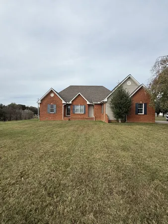 a view of house with outdoor space and garden