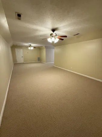 a view of an empty room and wooden floor