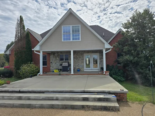 a view of a house with a chairs in patio
