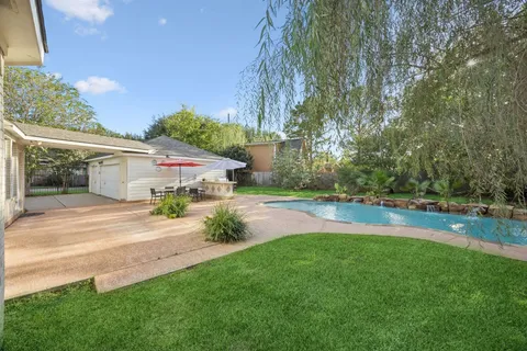 a view of yard with patio and dining table