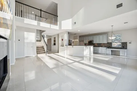 a view of kitchen with refrigerator and cabinets