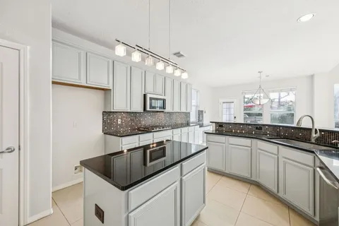 a kitchen with stainless steel appliances granite countertop a sink and cabinets