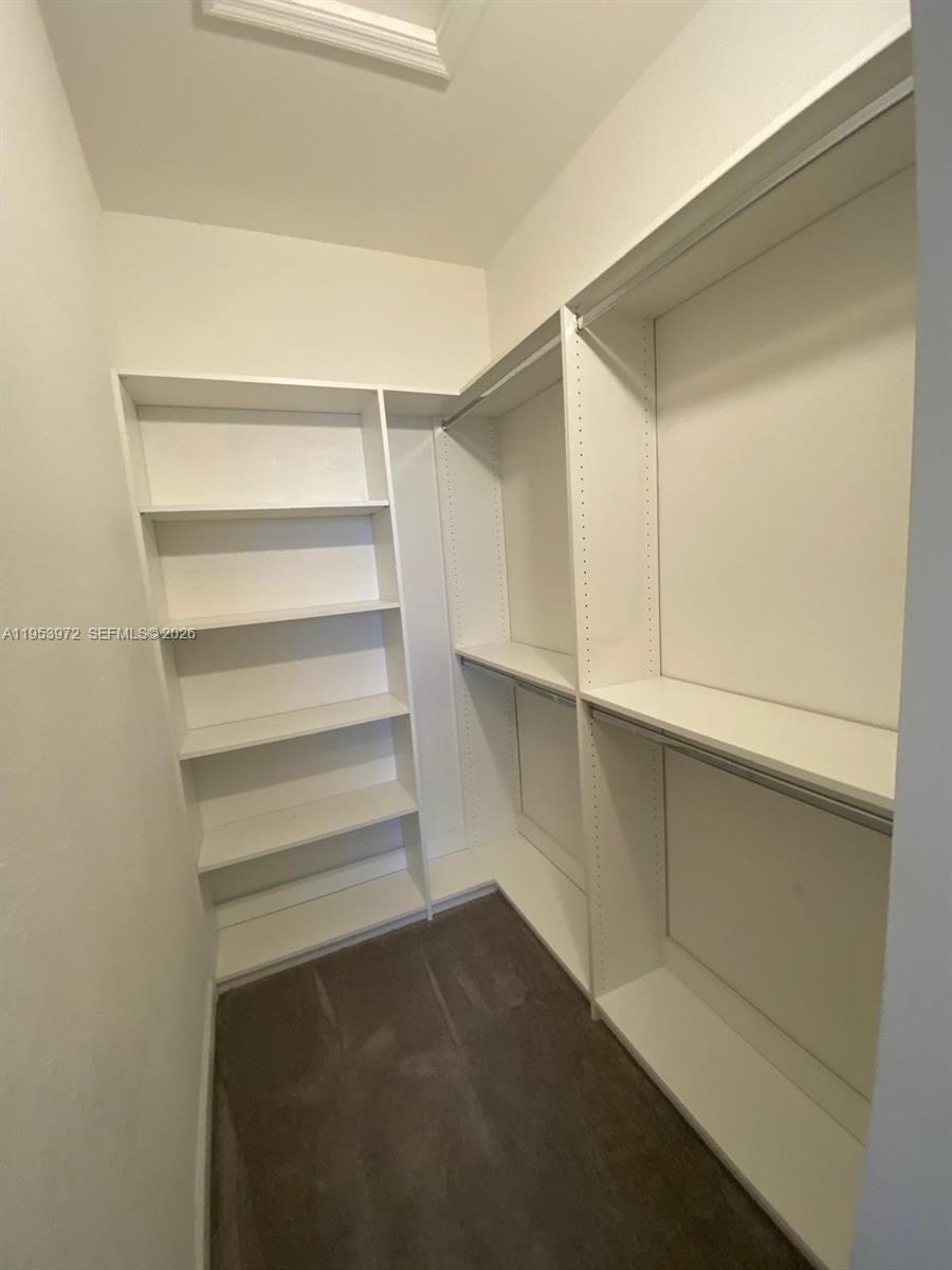 18220 Southwest 148th Road Miami, FL 33187 - Photo 13 of 23 a view of walk in closet with empty racks