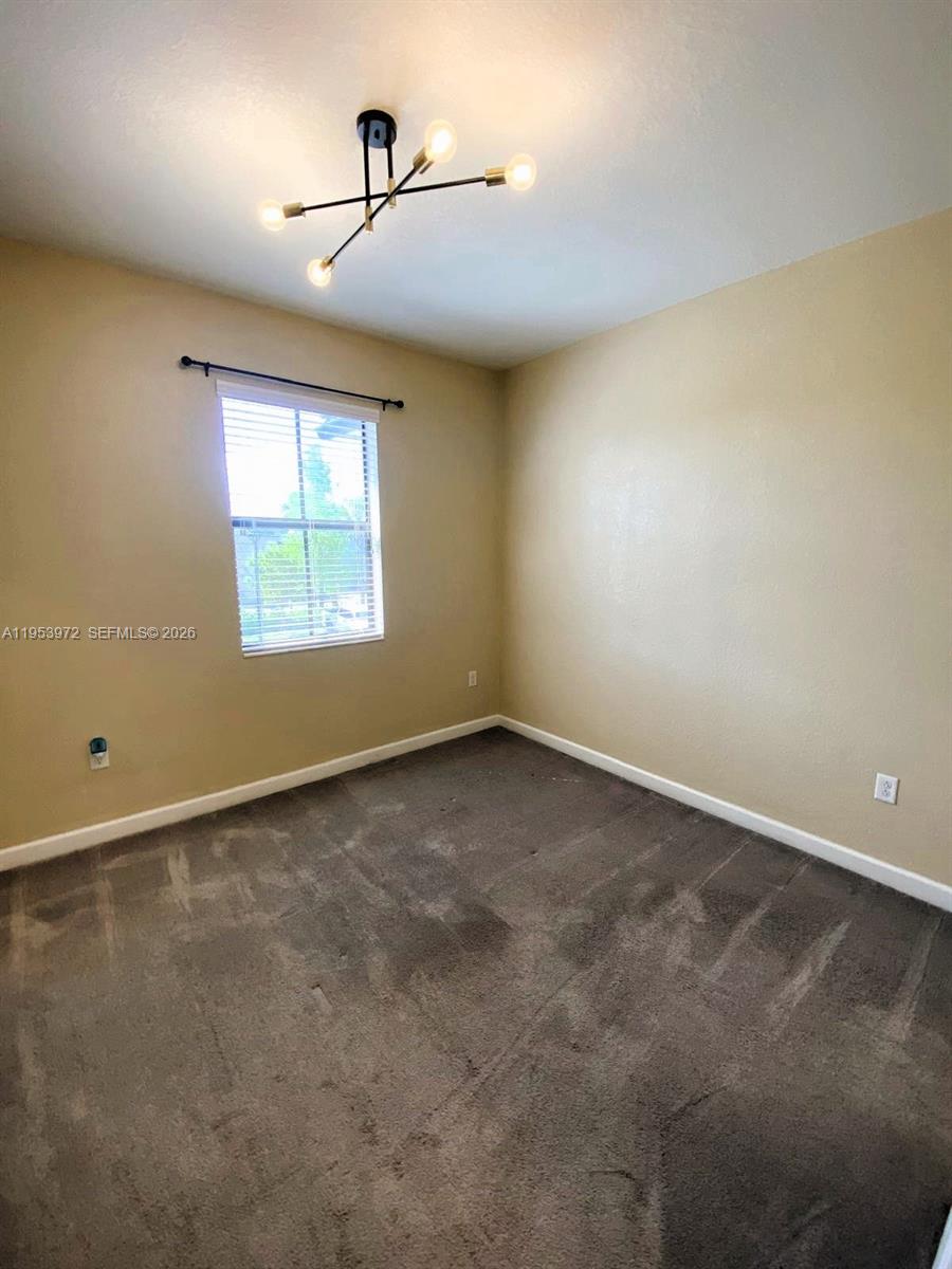 18220 Southwest 148th Road Miami, FL 33187 - Photo 15 of 23 an empty room with windows
