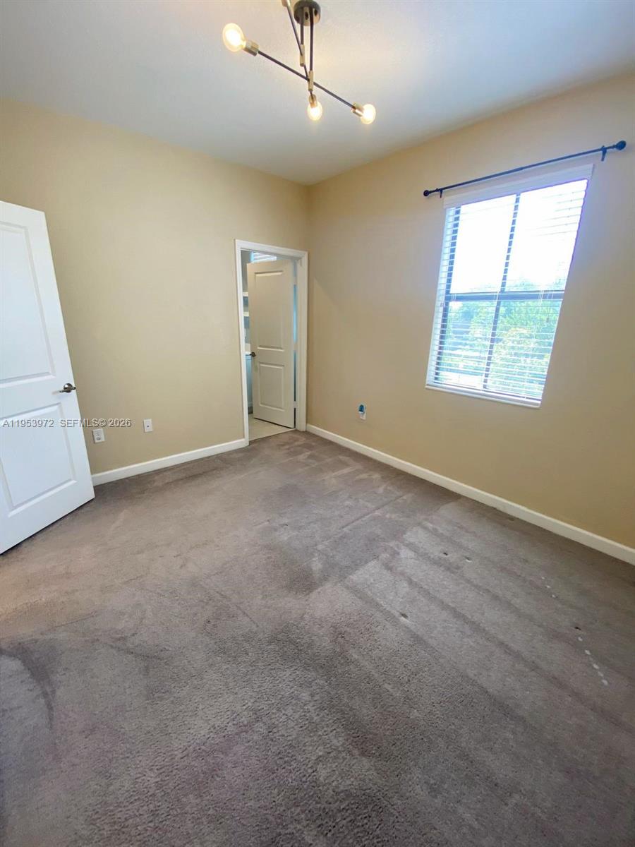 18220 Southwest 148th Road Miami, FL 33187 - Photo 16 of 23 an empty room with windows and entrance