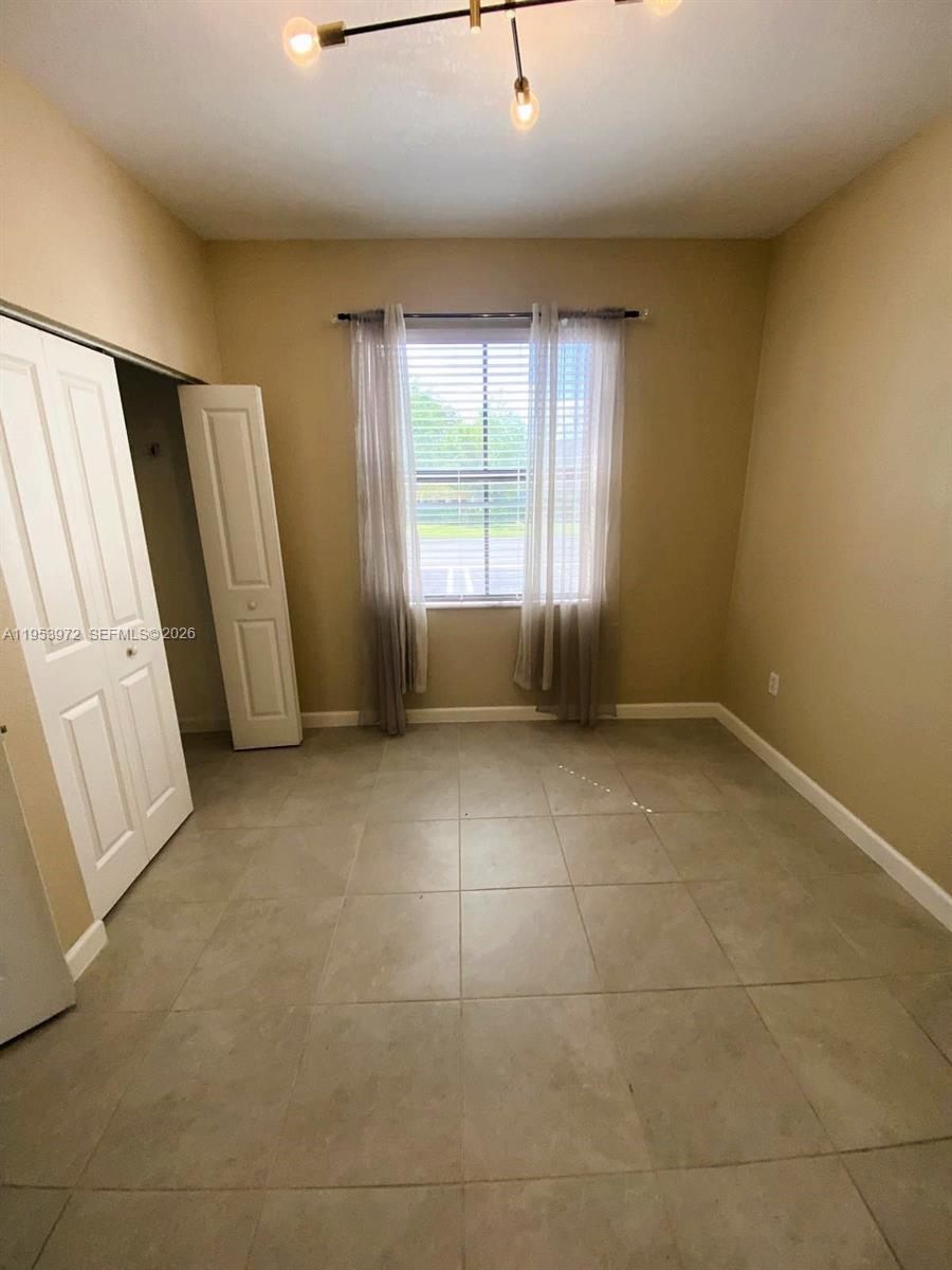 18220 Southwest 148th Road Miami, FL 33187 - Photo 3 of 23 a view of an empty room with a window