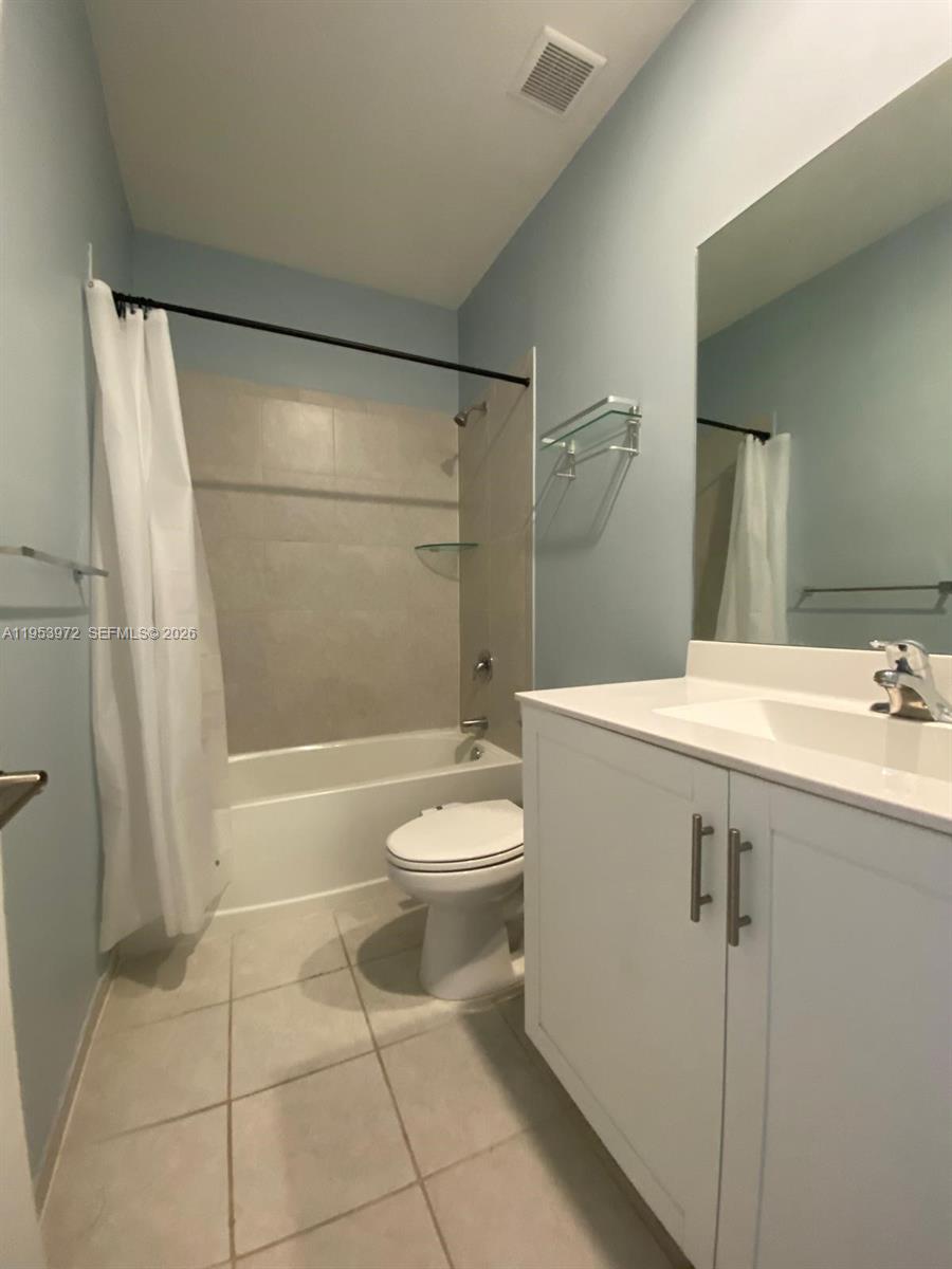 18220 Southwest 148th Road Miami, FL 33187 - Photo 4 of 23 a bathroom with a sink a toilet and shower