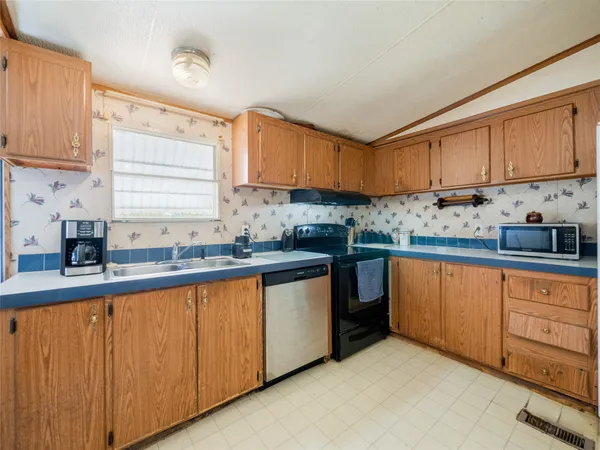 a kitchen with stainless steel appliances granite countertop a sink and cabinets