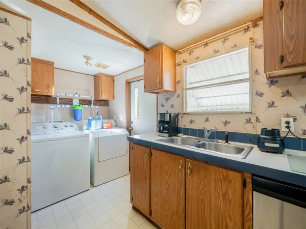 a kitchen that has a sink and a stove in it