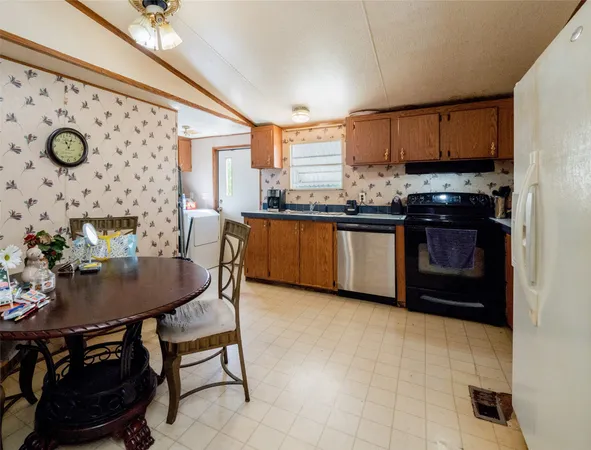 a kitchen with stainless steel appliances granite countertop a stove a sink dishwasher and a refrigerator