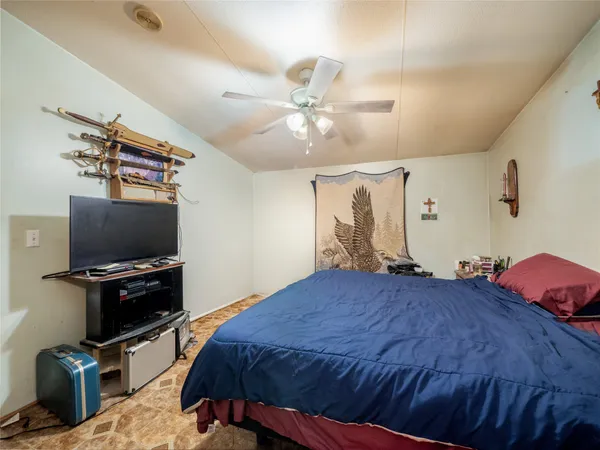a bedroom with a bed and a flat screen tv