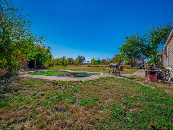 a view of a park with swings and trees