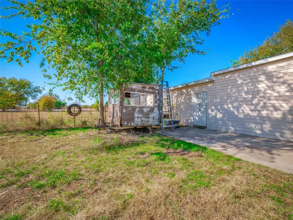 a view of a chairs and table in the patio