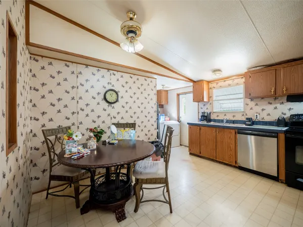 a kitchen with granite countertop a sink and white appliances