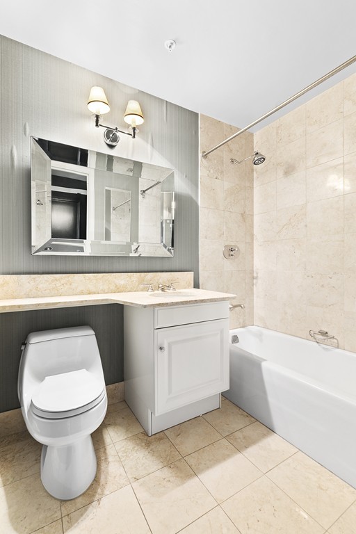 2 Avery Street, Unit 24H Boston, MA 02111 - Photo 11 of 14 a bathroom with a toilet sink and mirror