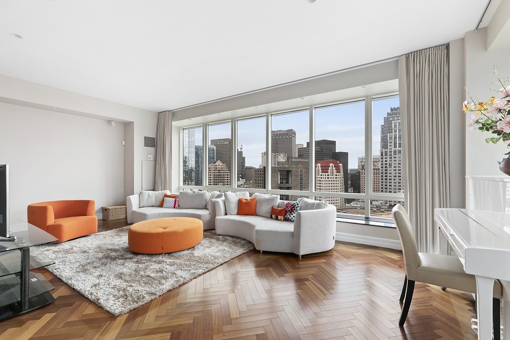2 Avery Street, Unit 24H Boston, MA 02111 - Photo 2 of 14 a living room with furniture and a floor to ceiling window