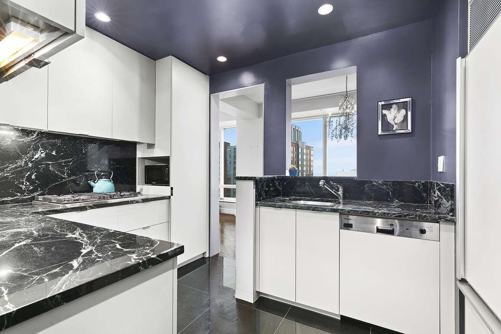 2 Avery Street, Unit 24H Boston, MA 02111 - Photo 4 of 14 a kitchen with stainless steel appliances granite countertop a sink and a stove