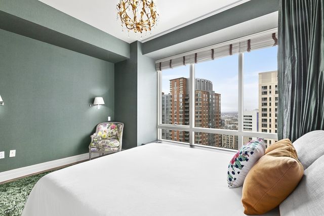 a bedroom with a bed and a large window