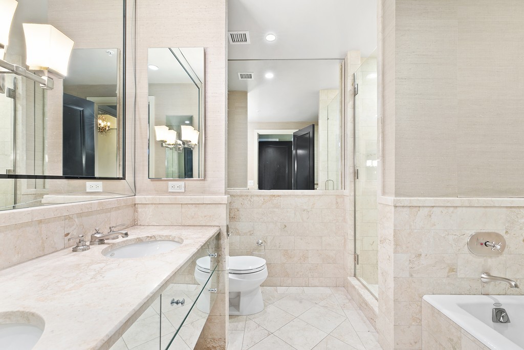 2 Avery Street, Unit 24H Boston, MA 02111 - Photo 8 of 14 a bathroom with a sink a toilet and shower