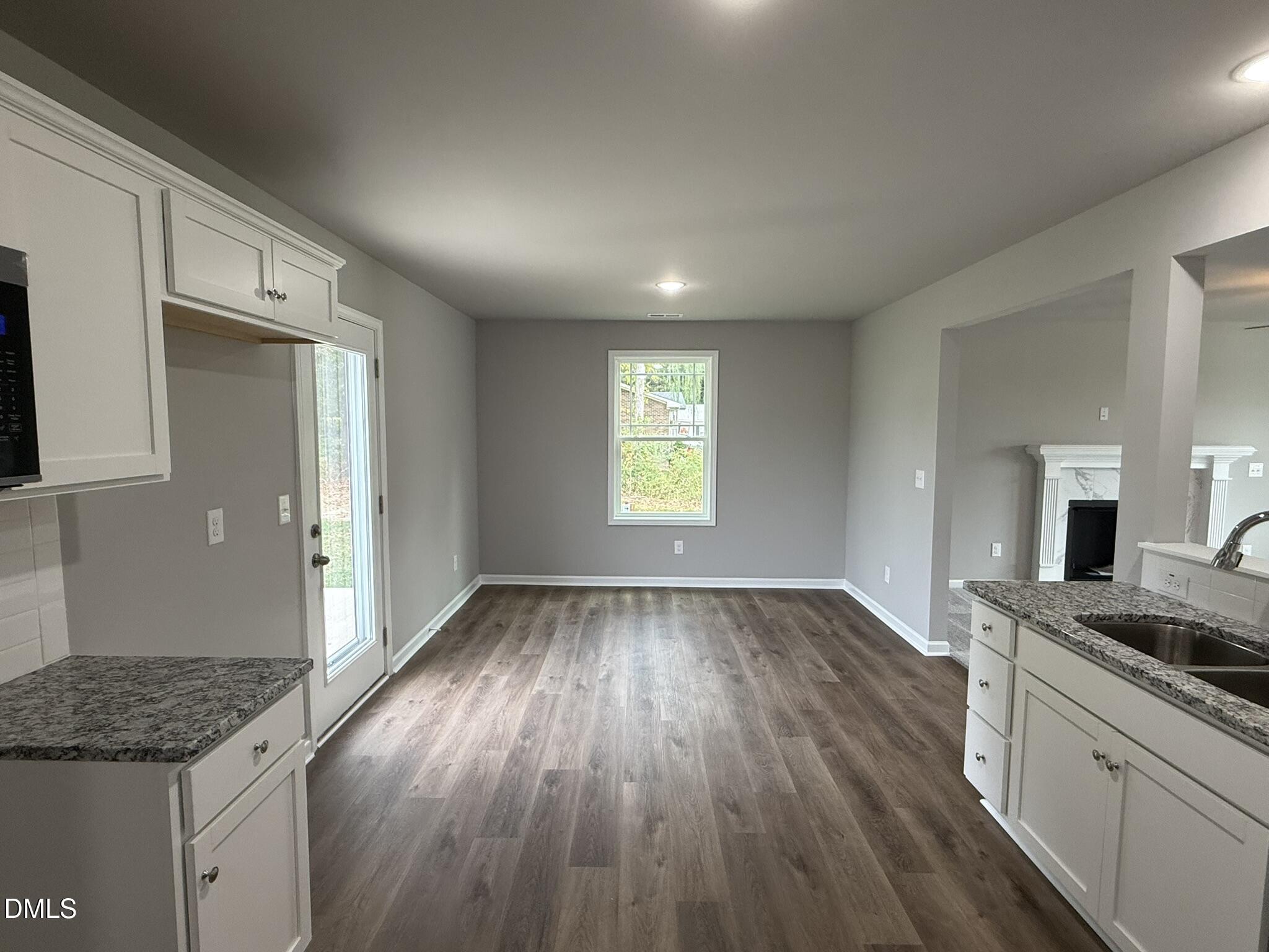 1859 Old Kenly Road Kenly, NC 27542 - Photo 12 of 22 a kitchen with granite countertop wooden floors a stove and a sink