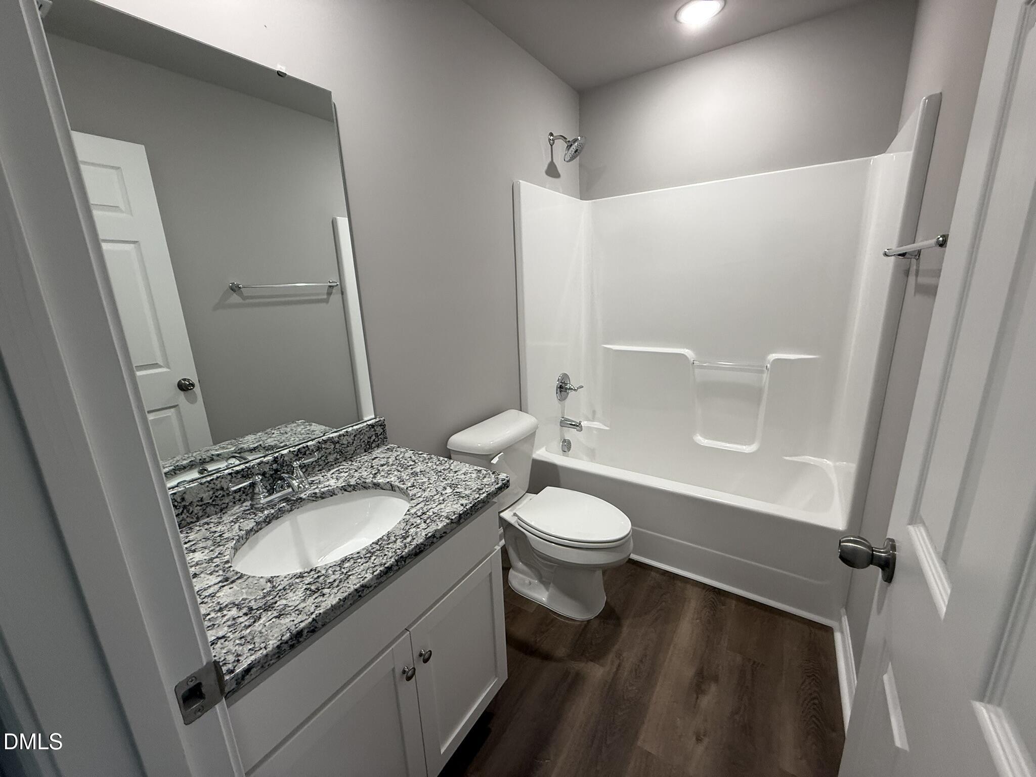 1859 Old Kenly Road Kenly, NC 27542 - Photo 20 of 22 a bathroom with a granite countertop sink toilet and shower