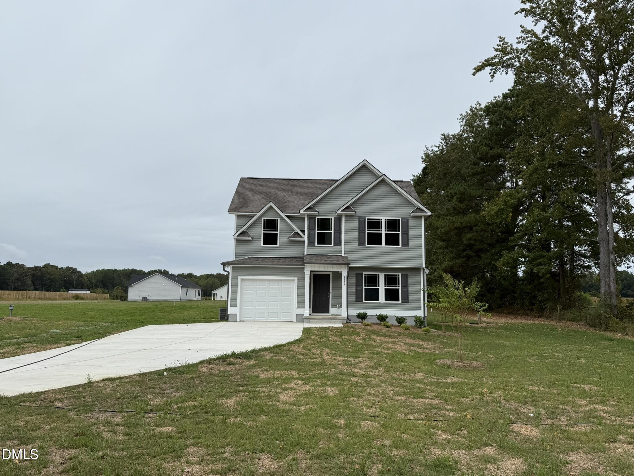 1859 Old Kenly Road Kenly, NC 27542 - Photo 2 of 22 a front view of a house with a garden