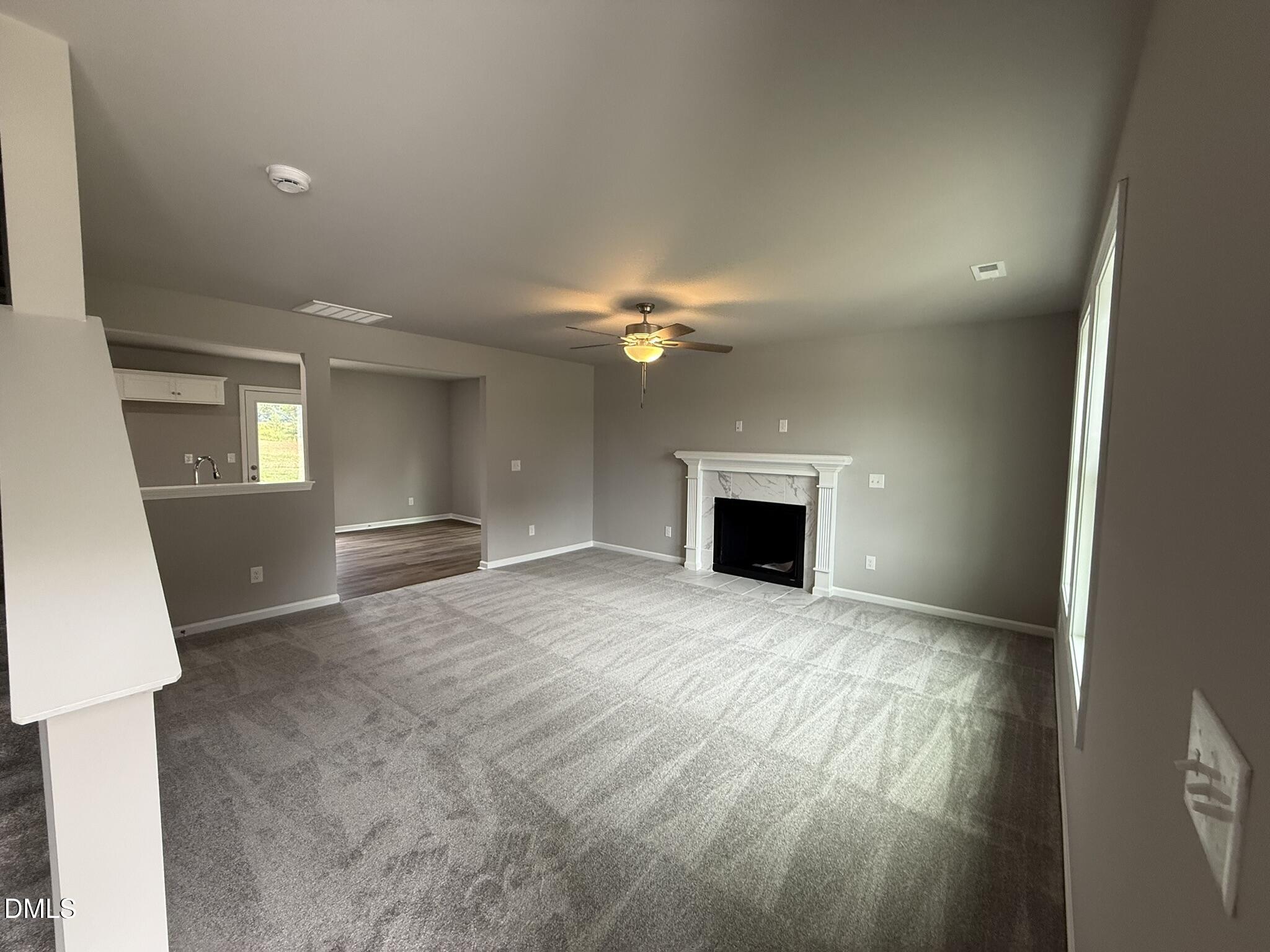 1859 Old Kenly Road Kenly, NC 27542 - Photo 4 of 22 a view of an empty room with a fireplace and a window
