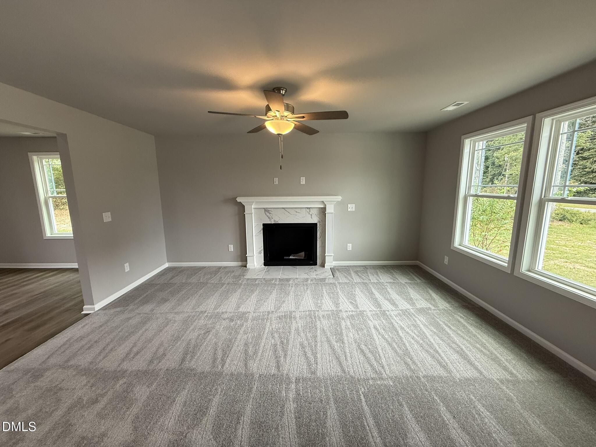 1859 Old Kenly Road Kenly, NC 27542 - Photo 5 of 22 a view of an empty room with a fireplace and a window